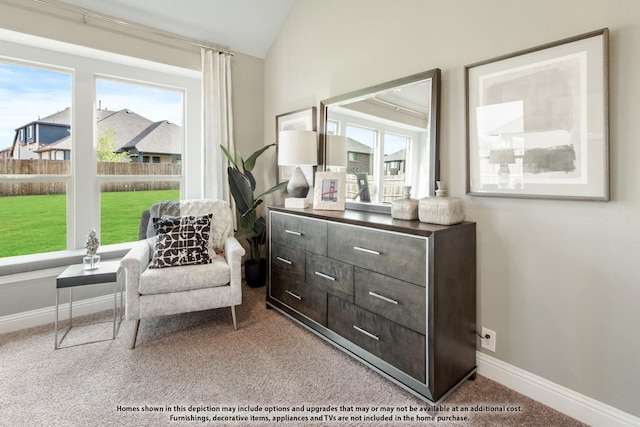 sitting room featuring lofted ceiling and light colored carpet