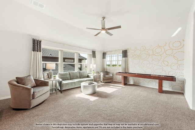 living room with vaulted ceiling, ceiling fan, and carpet flooring