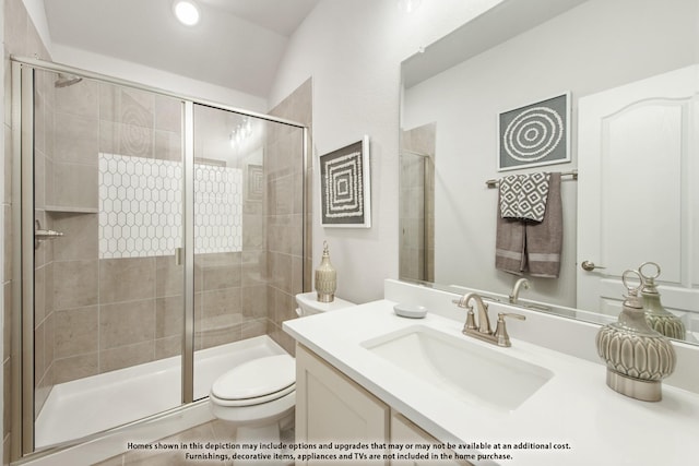 bathroom with vanity, vaulted ceiling, toilet, and a shower with door