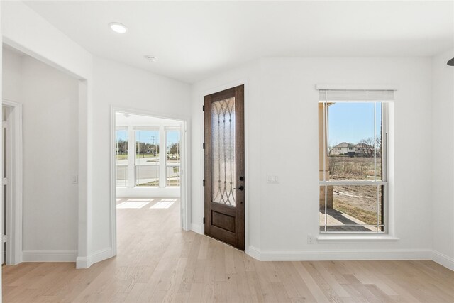 office space featuring a wealth of natural light, ceiling fan, and dark hardwood / wood-style floors