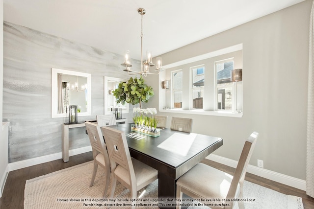 dining area featuring hardwood / wood-style flooring and a notable chandelier