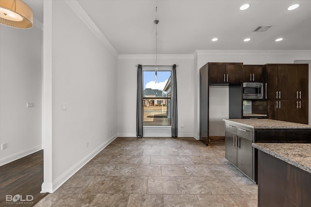 kitchen with dark brown cabinets, stainless steel microwave, light stone countertops, and crown molding