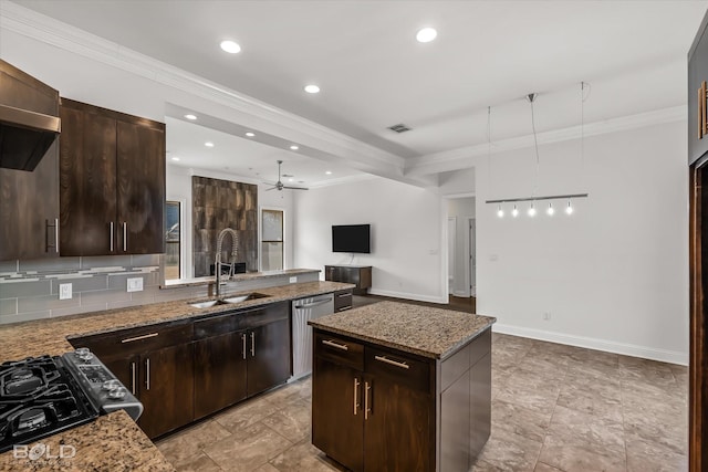 kitchen with dishwasher, sink, a kitchen island, and light stone countertops