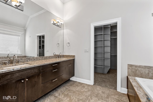 bathroom featuring vanity, a relaxing tiled tub, lofted ceiling, and ornamental molding