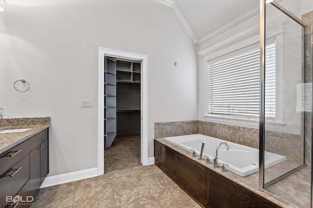 bathroom featuring lofted ceiling, independent shower and bath, ornamental molding, and vanity