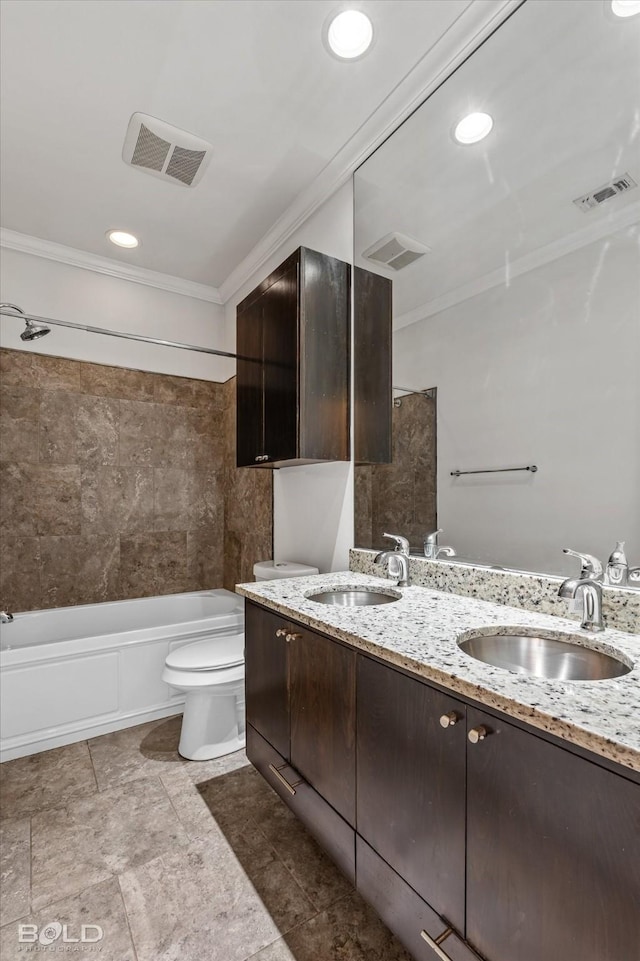 full bathroom featuring tiled shower / bath combo, crown molding, vanity, and toilet