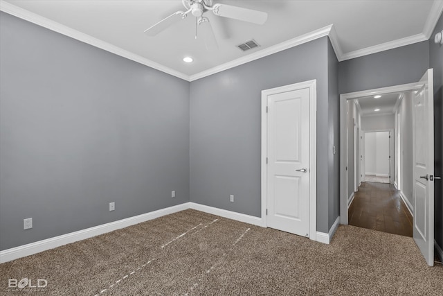 unfurnished bedroom featuring dark colored carpet, ceiling fan, and ornamental molding