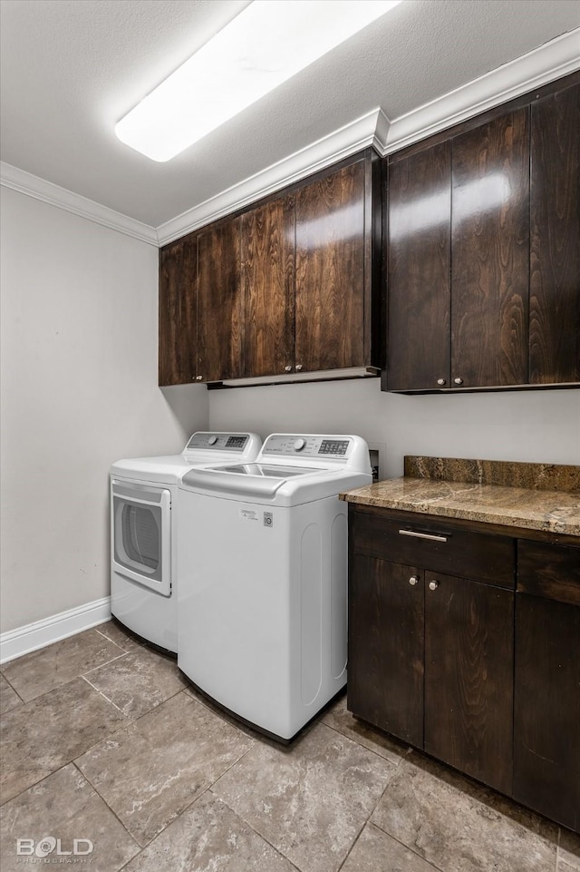 laundry room featuring crown molding, cabinets, and independent washer and dryer