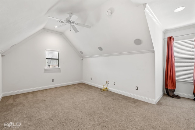 additional living space with light colored carpet, vaulted ceiling, and ceiling fan