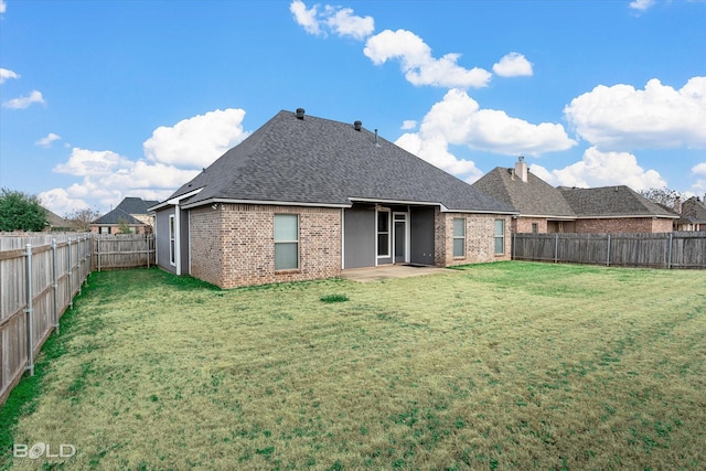 rear view of house with a patio and a yard