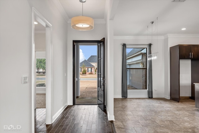 entrance foyer with crown molding and wood-type flooring