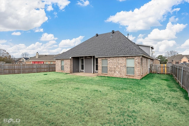 back of house featuring a patio area and a lawn