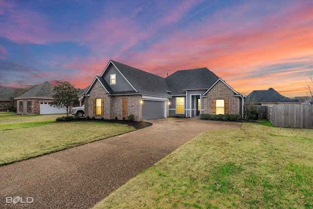 view of front facade featuring a garage and a yard