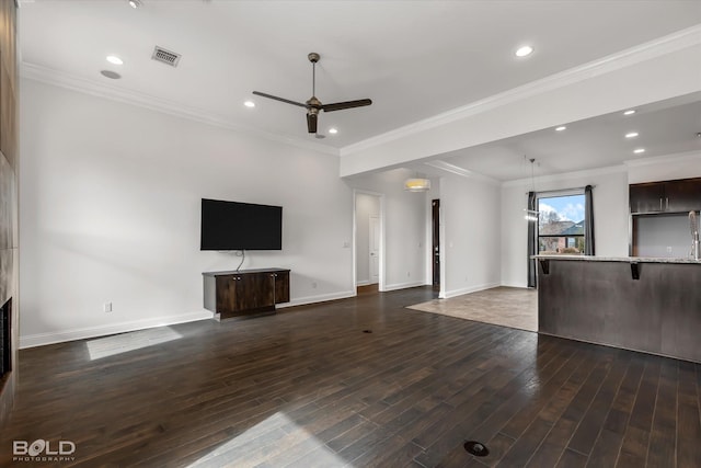 unfurnished living room with ceiling fan, ornamental molding, and dark hardwood / wood-style flooring