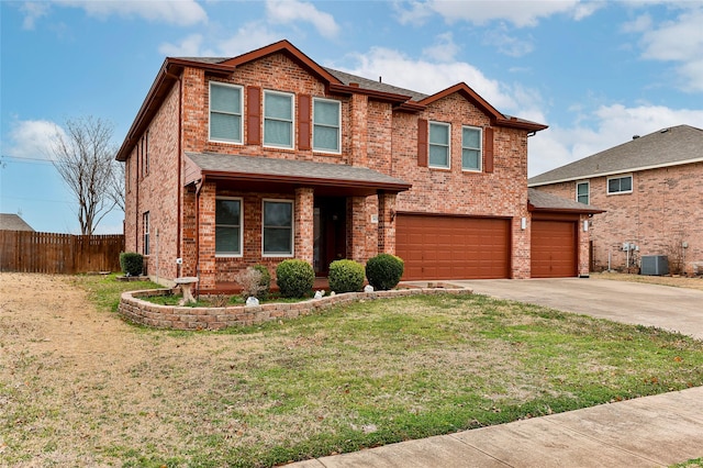 view of front of house with a garage, central AC, and a front yard