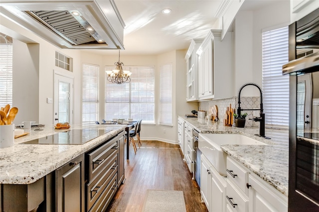 kitchen featuring an inviting chandelier, white cabinets, ventilation hood, tasteful backsplash, and dark hardwood / wood-style flooring