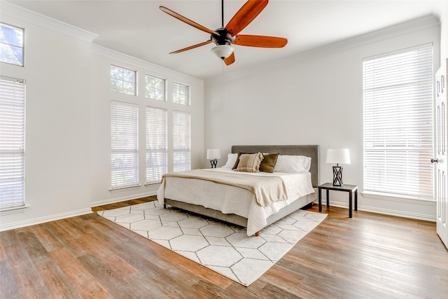 bedroom with light hardwood / wood-style floors, ceiling fan, and crown molding