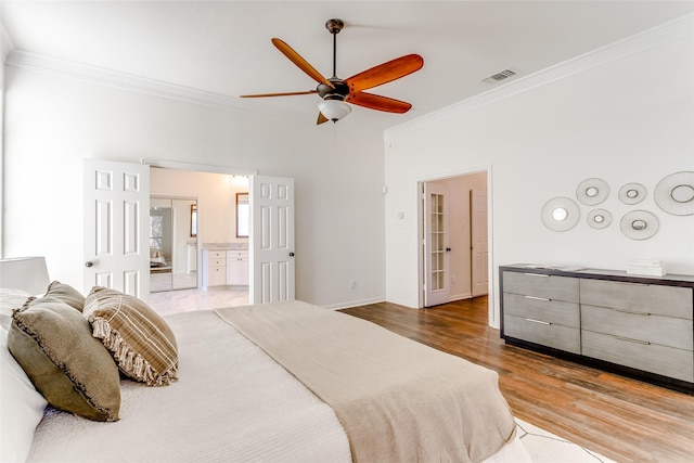 bedroom with ensuite bath, ceiling fan, hardwood / wood-style floors, and crown molding