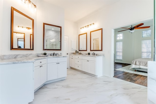 bathroom with hardwood / wood-style flooring, ceiling fan, and vanity