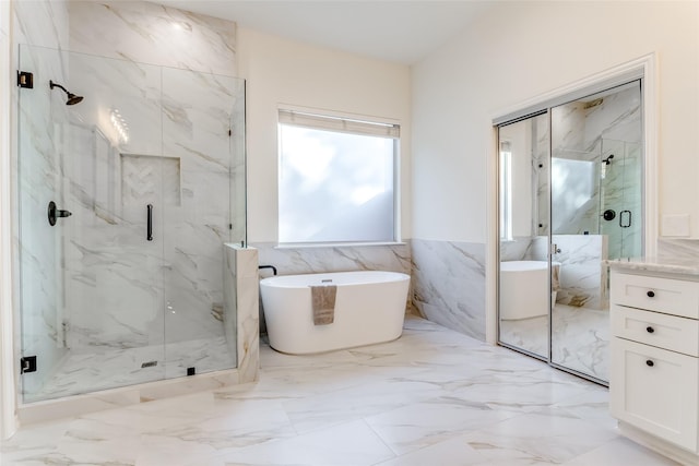 bathroom featuring vanity, shower with separate bathtub, and tile walls