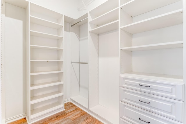 spacious closet with light hardwood / wood-style floors