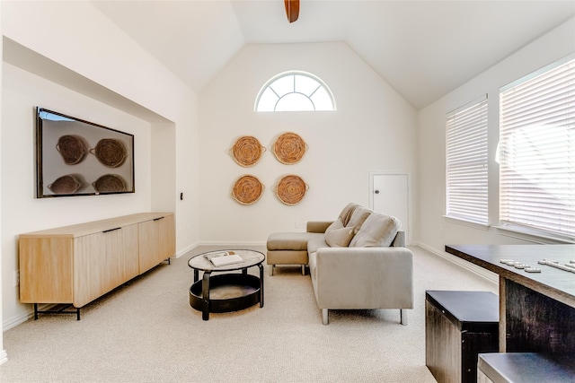 carpeted living room with ceiling fan and lofted ceiling