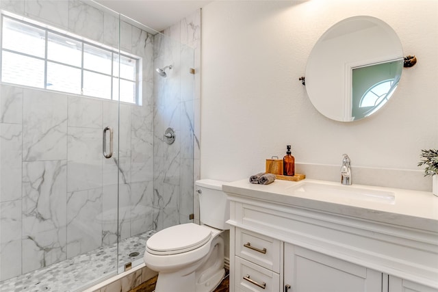 bathroom featuring vanity, toilet, and walk in shower