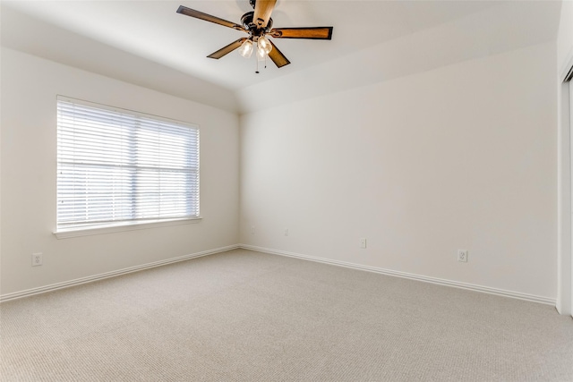 empty room featuring light colored carpet and ceiling fan