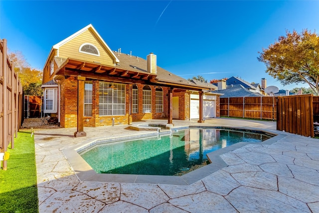 view of swimming pool with a patio area and an in ground hot tub