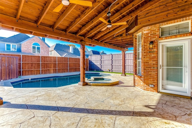 view of pool with a patio area, ceiling fan, and an in ground hot tub