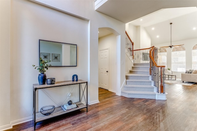 entrance foyer with wood-type flooring, high vaulted ceiling, and ceiling fan