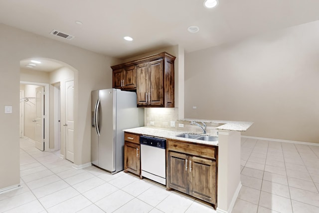 kitchen with dishwasher, backsplash, sink, light tile patterned flooring, and stainless steel fridge with ice dispenser