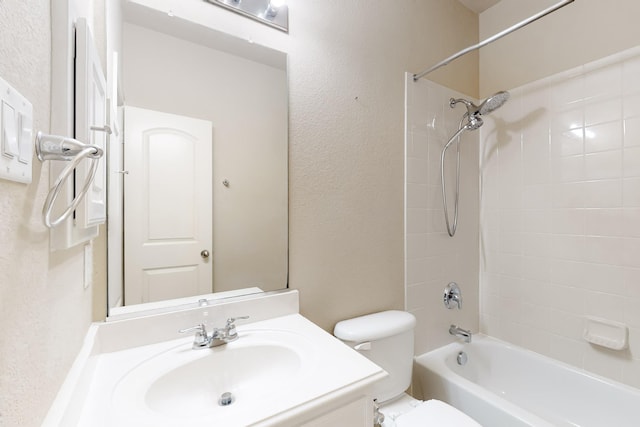 full bathroom featuring vanity, toilet, and tiled shower / bath