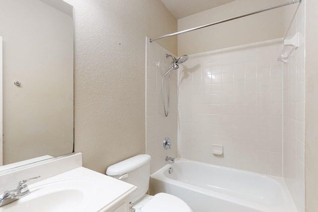 full bathroom with vanity, tiled shower / bath, and toilet