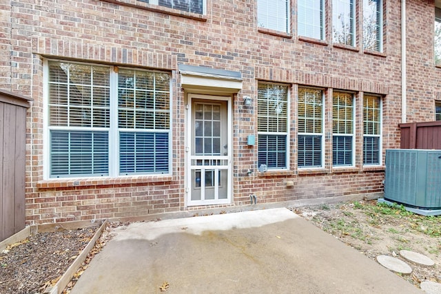 entrance to property featuring cooling unit and a patio