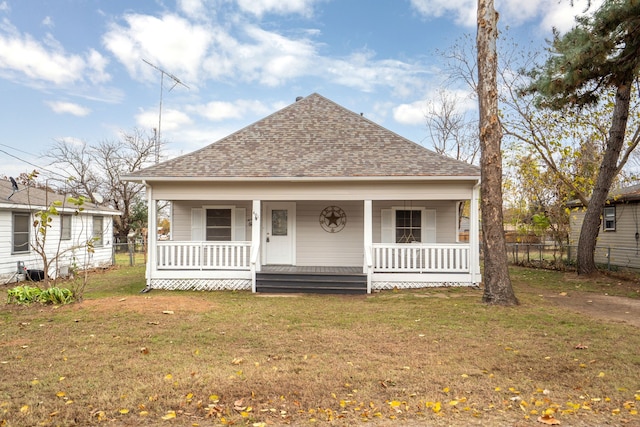 bungalow-style house featuring covered porch and a front lawn