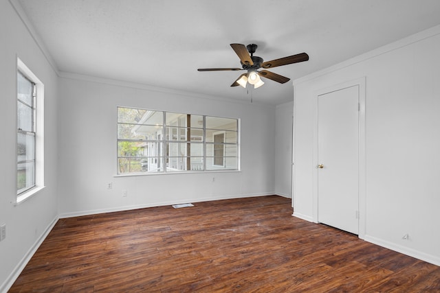 unfurnished bedroom featuring ornamental molding, ceiling fan, and dark hardwood / wood-style flooring