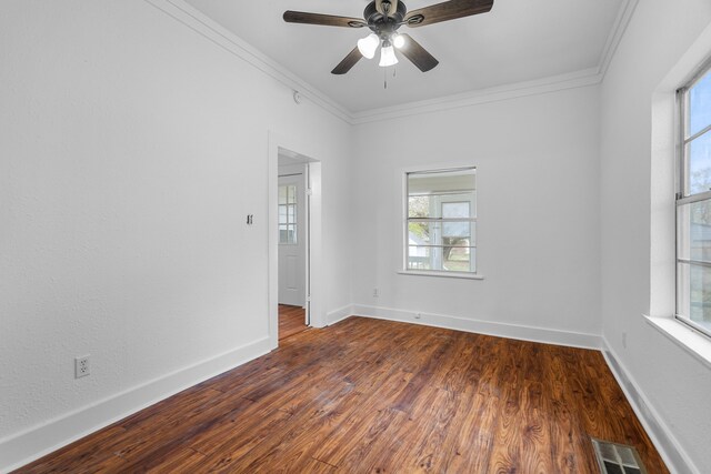 empty room featuring crown molding, ceiling fan, and dark hardwood / wood-style floors