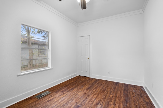 empty room with dark hardwood / wood-style floors, ceiling fan, and ornamental molding