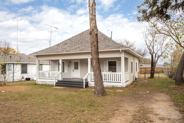 bungalow-style house with a front yard and covered porch