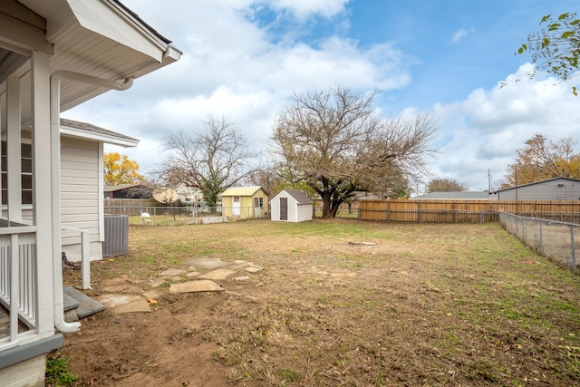 view of yard with cooling unit and a shed