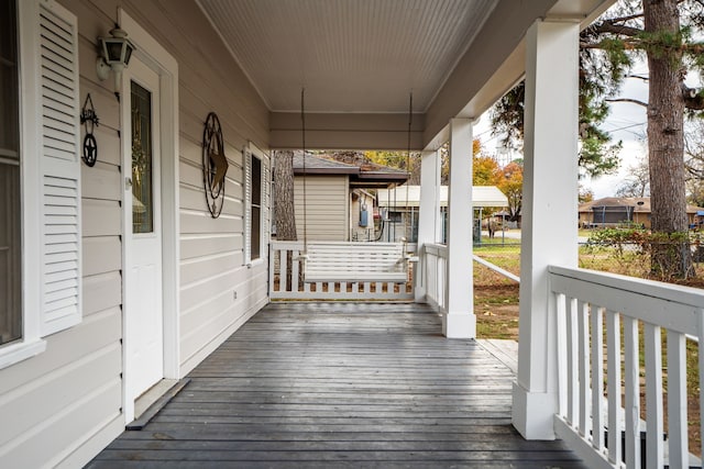 wooden terrace with a porch