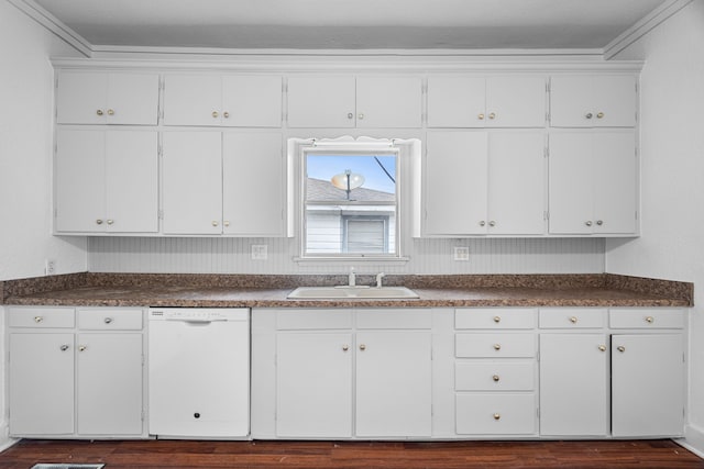 kitchen featuring white dishwasher, sink, and white cabinets