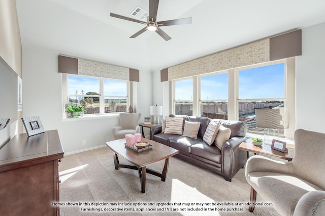 carpeted living room featuring a wealth of natural light and ceiling fan