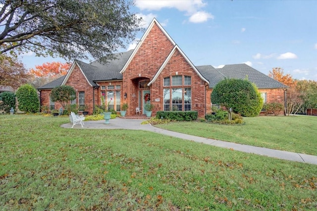 1305 Bentbrook Ln, Sherman, TX 75092 - view of front facade with brick siding, a front yard, and a shingled roof