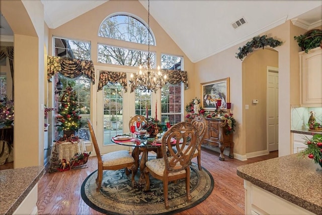 1305 Bentbrook Ln, Sherman, TX 75092 - dining room featuring light wood-style flooring, a chandelier, ornamental molding, and high vaulted ceiling