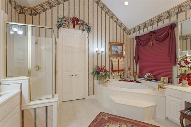 bathroom featuring vanity, vaulted ceiling, tile patterned floors, and independent shower and bath