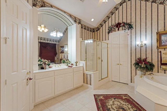 bathroom featuring tile patterned flooring, vanity, separate shower and tub, and vaulted ceiling