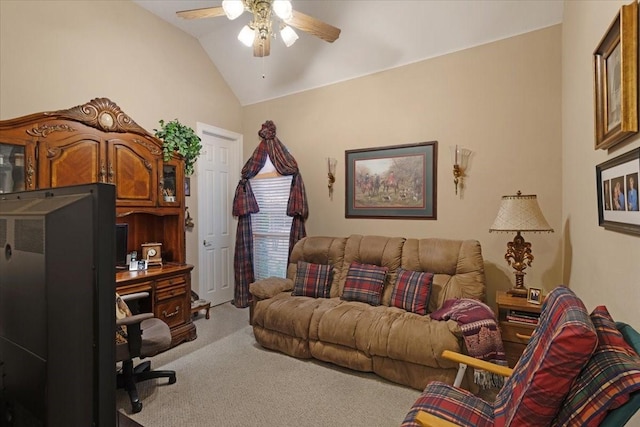 carpeted living room with ceiling fan and vaulted ceiling