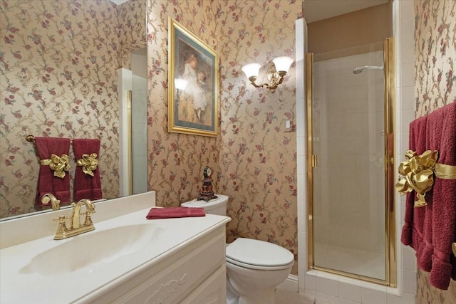 bathroom featuring toilet, an enclosed shower, and vanity